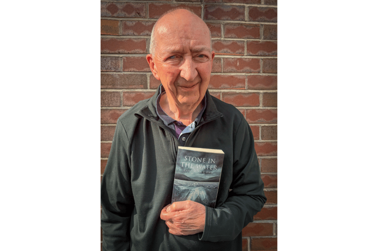 Richard Wynn-Jones with a copy of his book