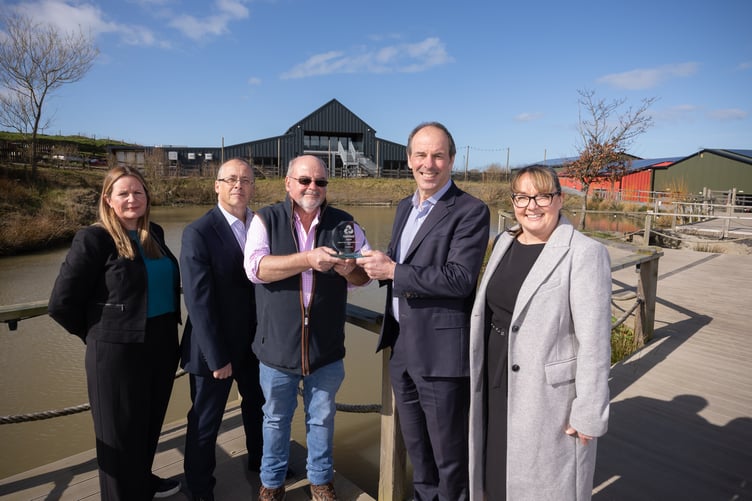 11.03.25  NatWest Cymru Green Business of the Year Award, Bargoed Farm, Llwyncelyn - Geraint Thomas, owner of Bargoed Farm receives the NatWest Cymru Green Business of the Year Award from James Close, Head of Climate Change for NatWest Group, along with, left to right, Rhiannon Matthews, General Manager at Bargoed Farm; Rhys Williams, Director of Commercial Banking for Swansea and West Wales, and Victoria Morgan, Senior Relationship manger for NatWest, right.