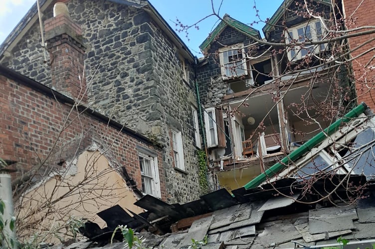 Another rear view showing the partial collapse of two bedrooms