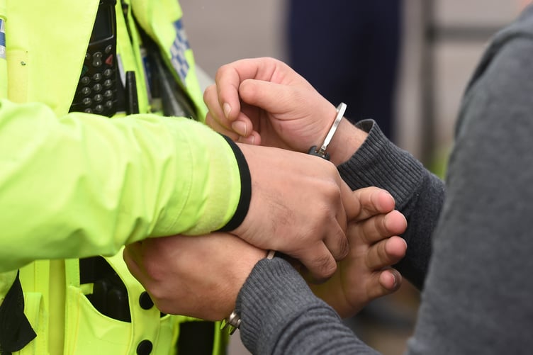 An uninsured driver is handcuffed by police for breach of the peace