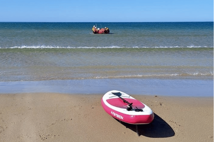 Paddleboard and RNLI crew after rescue. Photo:
RNLI/Sarah Radford
