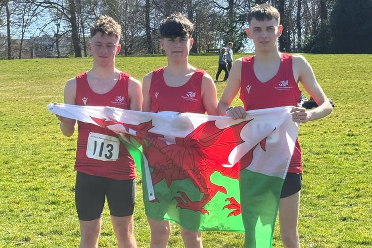 Grŵp Llandrillo Menai learners (left to right) Tomos Morgan, Elis Jones and Noa Vaughan holding the Wales flag at the AoC Sport National Championship