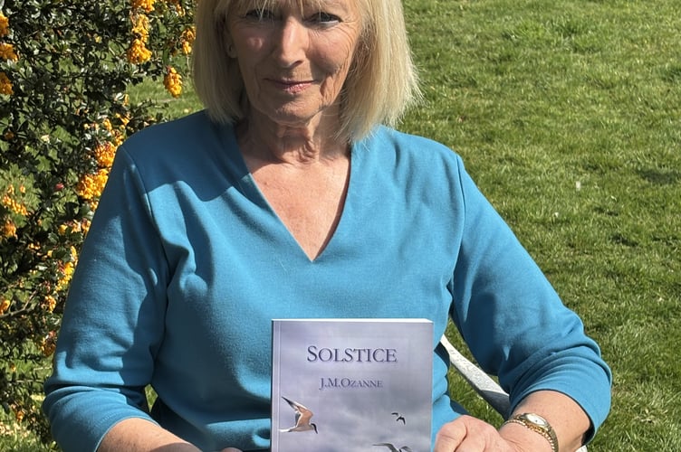 J. M. Ozane with a copy of her new novel, 'Solstice'