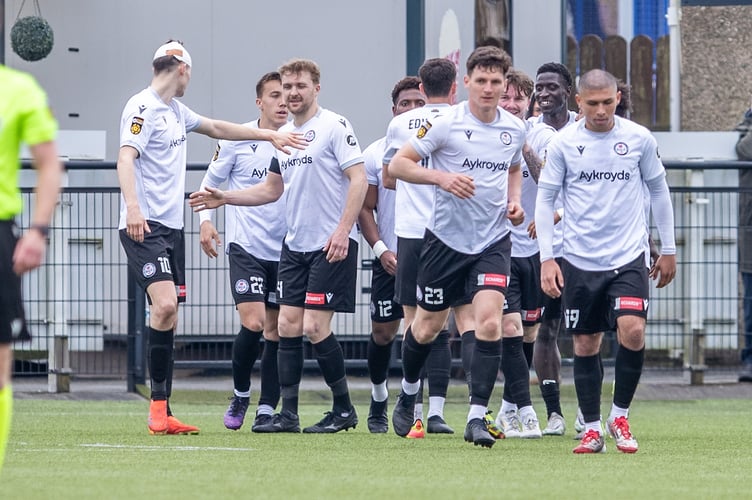 BALA, WALES - 19TH APRIL 2025: Bala Town players celebrate their opening goal during the JD Cymru Premier fixture between Bala Town and Penybont at Maes Tegid, Bala. 19th of April, Bala, Wales (Pic by Nik Mesney/FAW)