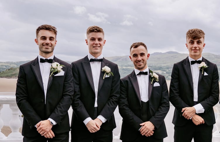 Lloyd Hughes next to his brother Harri (far right) who was paralysed in a car accident, and his other brothers Aidan and Ellis