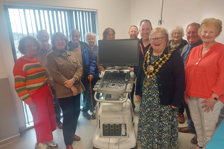 Pictured are Friends Chair Catrin Miles, Cardigan mayor Cllr Olwen Davies and Dr Treharne with committee members and centre staff. 