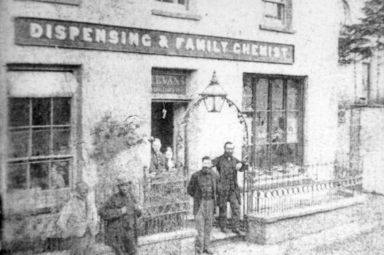 This photograph shows the Golden Mortar Chemist when it run by Joshua W Evans, possibly from the last 19th century, early 20th century