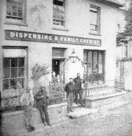 This photograph shows the Golden Mortar Chemist when it run by Joshua W Evans, possibly from the last 19th century, early 20th century