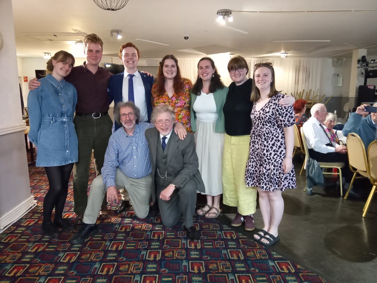 Several ACS student members with choir chair, Gareth Kelly, and musical director, David Russell Hulme