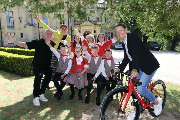Tony and Donna Cooper-Barney with the pupils of Ysgol Betws Gwerful Goch and their teacher Hannah Blackford at Palé Hall