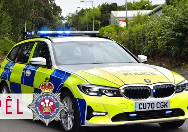 Car damaged on country road after tyre falls from trailer