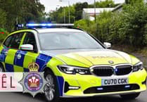 Car damaged on country road after tyre falls from trailer