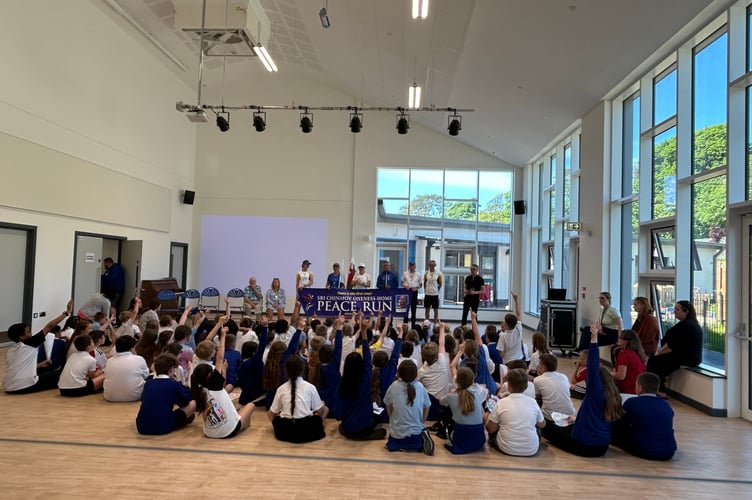 The children of Ysgol Treferthyr listen to the peace runners