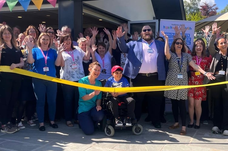 The crowd cheered as the ribbon was cut by Kyle
