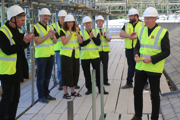 Rhodri Llwyd Morgan, Chief Executive of the National Library of Wales, right, led the topping off ceremony