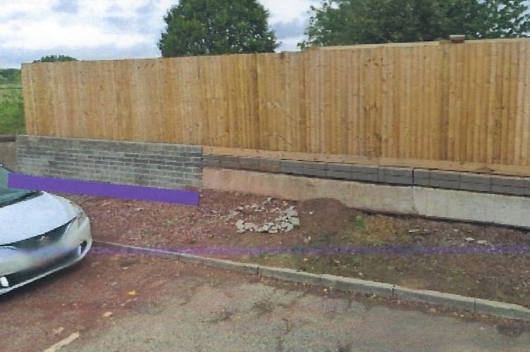 The purple line drawn on the photograph, at the far end of the wall, shows where the garden wall and fence had been extended across the previous entrance to the