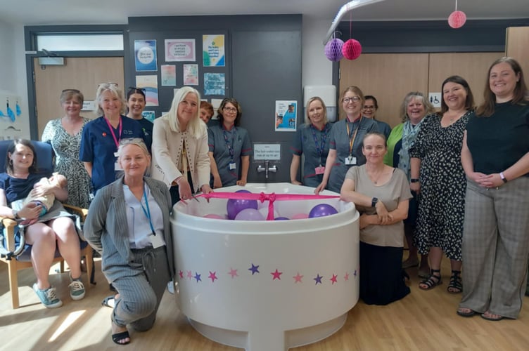 Gwenllian ward staff, CBLF representative Rhian Davies (2nd from right), Karen Jewell from Welsh Government (6th from left), mum Marie Mickiewicz and daughter Ripley (left), and the new pool. Photo: Julie McNicholls Vale