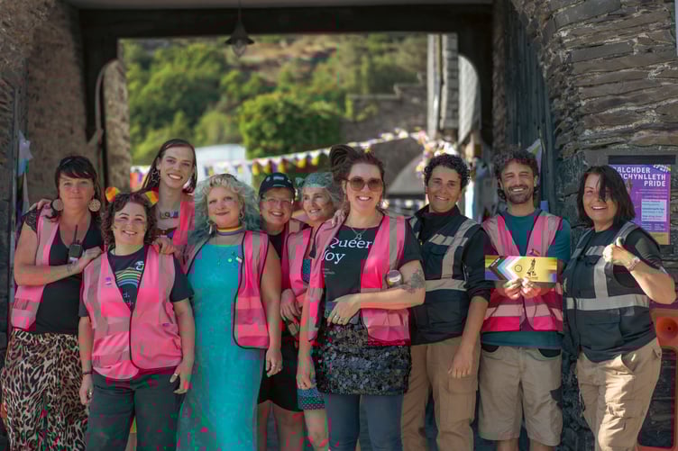 The Balchder Machynlleth Pride team, volunteers, and security guards from Comet Security Group at 2025 Machynlleth LGBTQ+ Pride hosted by the Owain Glyndŵr Centre
