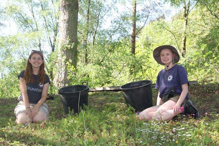 One method of slowing water flow is through green roofs, as seen here being maintained by volunteers at Machynlleth's Centre for Alternative Technology