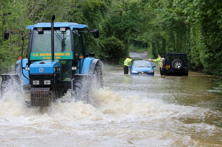 Photo Code APJ14J10 Photo Arvid Parry Jones 14June12 Ref Dylan; 
Elderly couple resqued fro their trapped vehicle at Loves Grove Near Aberystwyth. - A44 Road Closed.
 