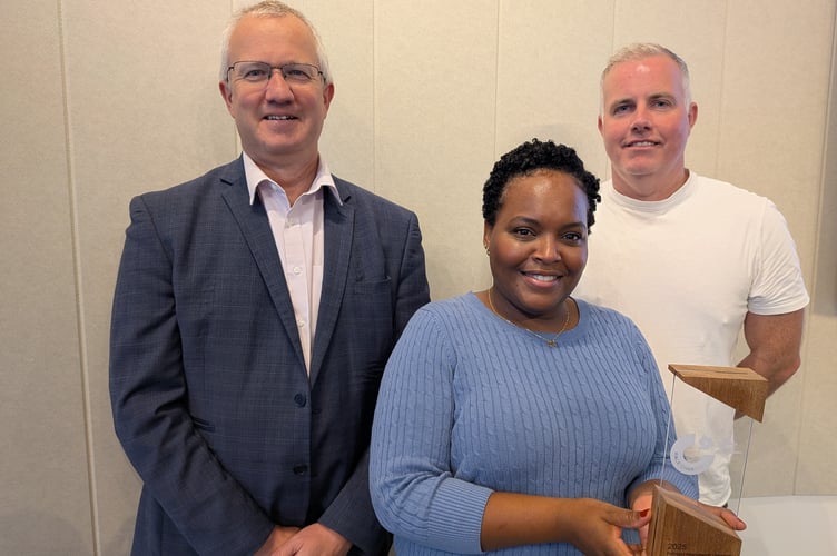 Aberystwyth University Vice-Chancellor Professor Jon Timmis, Race Equality Officer Sheree-Ann Jonas, holding the Race Equality Charter Bronze Award, and Diversity and Inclusion Manager Dylan Eurig Jones