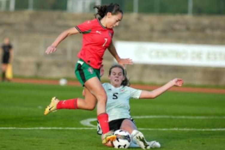 Aberystwyth's Katie Whiteway slides in to make a  well-timed tackle for Wales