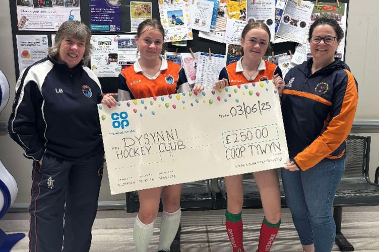 Left to right: Lynda Bennett (head coach) and hockey club members Evie, Molly and Crona Hodges