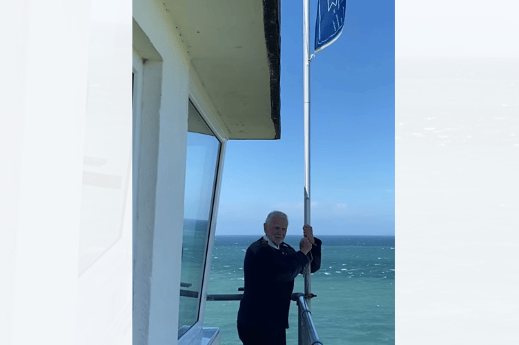 David Littlemore raising the NCI flag at Porthdinllaen