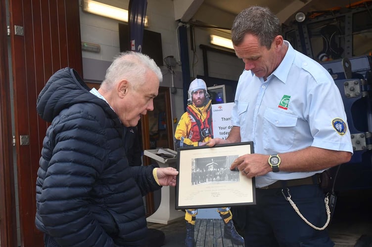 Aberdyfi Senior Helm Will Stockford pointing out a picture of Alun's grandfather- an Aberdyfi Lifeboat crew member in the early 1900's. Photo: Doris O'Keefe