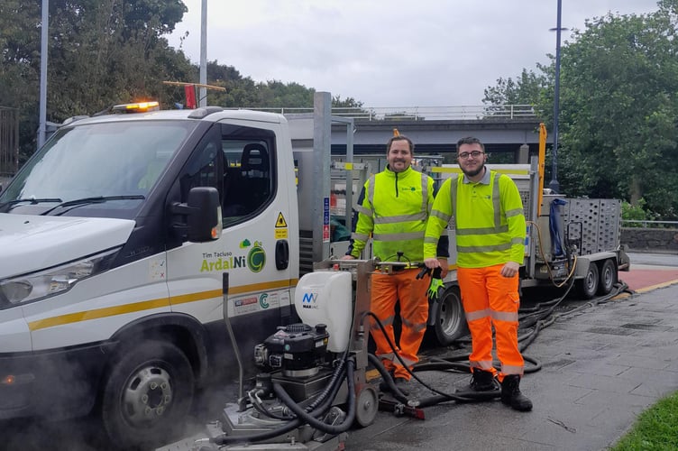 Members of the Timau Tacluso Ardal Ni – Justin and Dion – with the new machine cleaning the streets of Caernarfon. Photo: Gwynedd Council