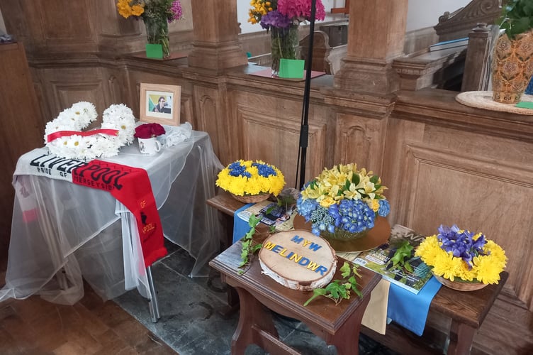 A touching tribute to Liverpool fan Carwyn Daniel, and flowers celebrating Melindwr. Photo: Julie McNicholls Vale