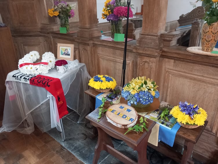 A touching tribute to Liverpool fan Carwyn Daniel, and flowers celebrating Melindwr. Photo: Julie McNicholls Vale
