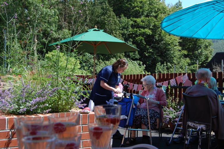 Resident Anne enjoying the party in the new garden