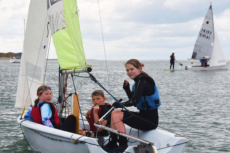 Skye Neville, assistant DYC instructor, with two of the children