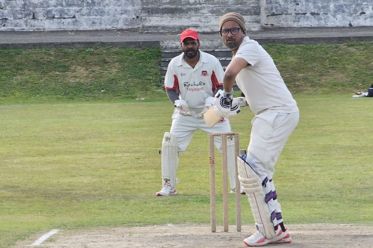 Lahiru Chamil takes guard, watched by Sumesh Antony