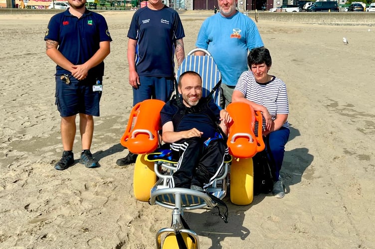 Back row from left: Harbour Master Kane Triggs, Deputy Mayor Damian Williams, Mayor Robert Williams. Front row from left: Conan Ingram in the new wheelchair, and Barmouth Town Council Clerk Heather Brown