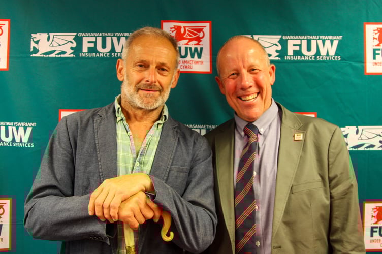 Alun Elidyr received a shepherds crook from FUW President Ian Rickman. Photo: FUW