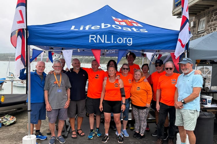 Sion Cwilt Rowing club with members of New Quay RNLI and New Quay YC after the rowathon. Photo: RNLI
