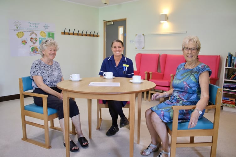 Machynlleth League of Friends secretary Ceri Morgan, Bro Ddyfi Senior Sister Jenny Roberts and League Chair Myra Francis on the new chairs and tables at Bro Ddyfi Community Hospital