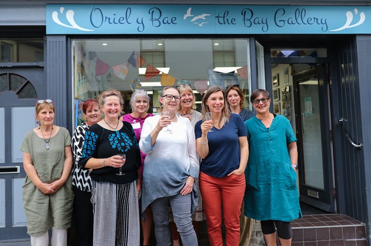 Gallery owner Jeni Pain, centre, with some of the artists who are exhibiting their work at the venue. Photo: Claire Stott