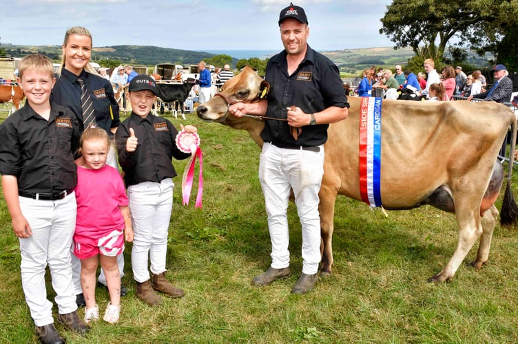 Euros Evans and his family from Bryngwyn with their prize winning champion Jersey cow