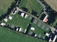 Camp site operated “without benefit” of planning permission