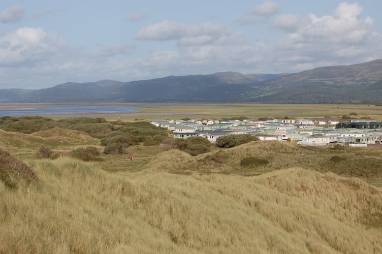 In the middle distance, the path that Ashley was last seen on. In the background, Searivers Caravan Park and beyond, the Dyfi Estuary. In the foreground, the dunes of Ynyslas Nature Reserve.
