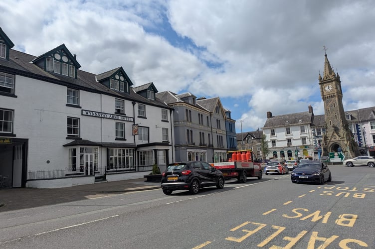 The Wynnstay Hotel (left) whose business is being affected by the clock chimes at night (right). Photo: Cambrian News