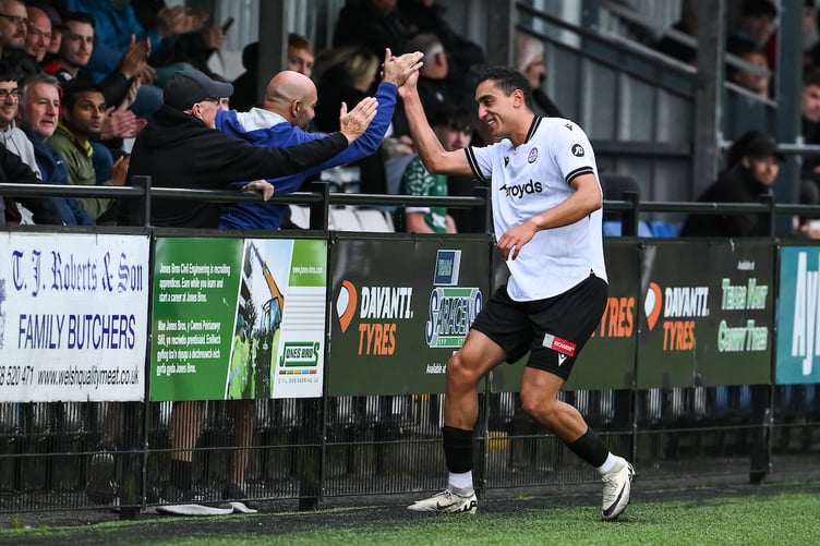 BALA, WALES - 08 AUGUST 2025: Hussein Mehasseb of Bala Town hi fives a fan as he celebrates his goal to make the score 1-0 during the JD Cymru Premier between Bala Town and Flint Town at the Maes Tegid in Bala on the 08th August 2025. (Pic by Craig Thomas/FAW)