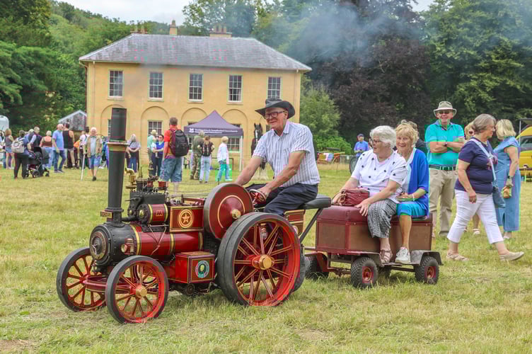 Dai Thomas with his newest minature staeamer gives a lift for two people around the showfield