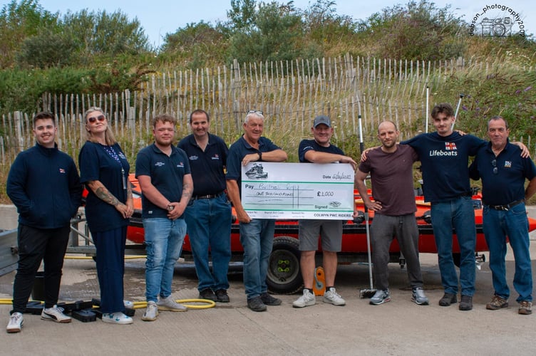 Cheque for £1,000 from Colwyn PWC Riders being presented to Pwllheli RNLI. Photo: RNLI/Dion Dobson