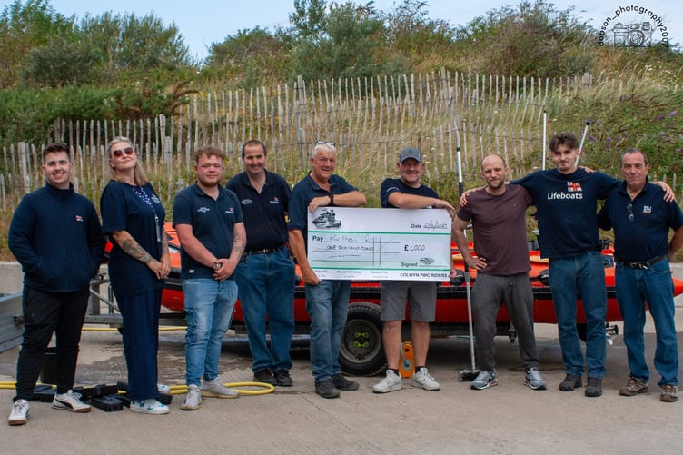 Cheque for £1,000 from Colwyn PWC Riders being presented to Pwllheli RNLI. Photo: RNLI/Dion Dobson