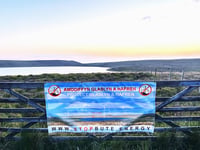 Anti-wind farm banner 'stolen' from gate for fifth time