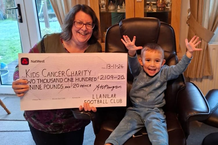 Gary’s grandson, Zebedee, presenting last year’s cheque to Ann White of Kids Cancer Charity (Wales)